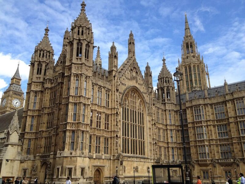 Gothic-style building with towers and stained glass windows on a clear day.