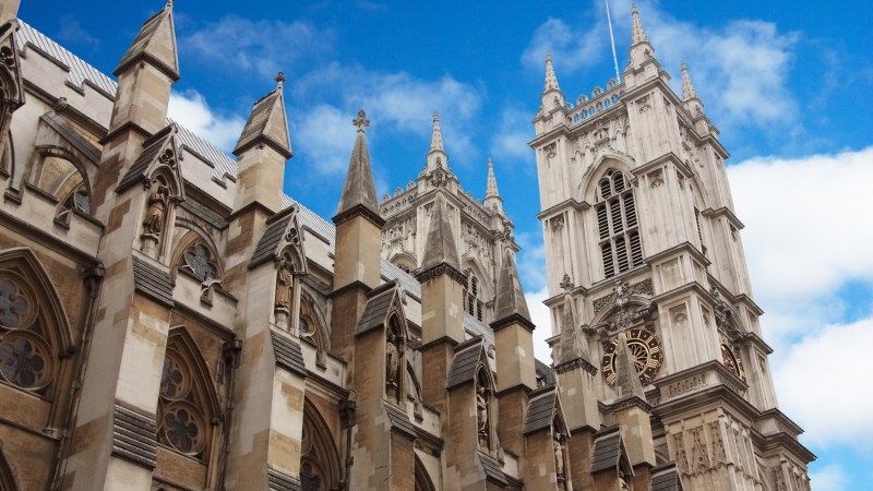 Gothic-style cathedral with two towers against a blue sky.