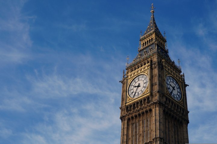 Big Ben clock tower against a blue sky with clouds.